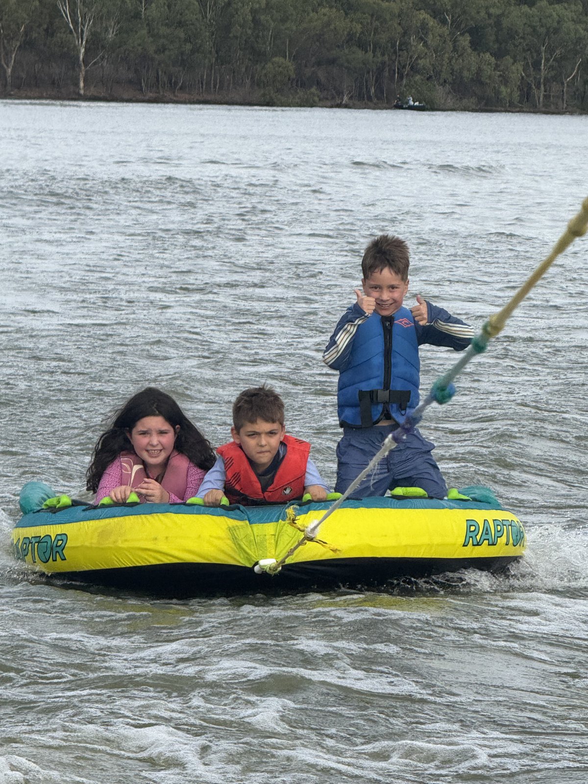 Children enjoying a kayak together on the river